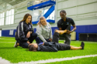 Students learn about athletic training and different techniques in an exercise and nutrition sciences class at the Murchie Family Fieldhouse in November 2021. The class is led by professors Ryan Krzyzanowicz and Sarah Krzyzanowicz, in the School of Public Health and Health Professions. Photographer: Douglas Levere