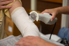 Occupational therapy Students participate in a prosthetics and orthotics lab in April 2022 at Kimball Hall. They were tasked with making arm and finger casts. Photographer: Meredith Forrest Kulwicki 