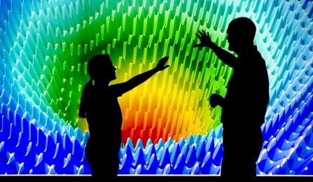 Two people standing in front of a projection screen at the Clinical and Translational Science Institute. 