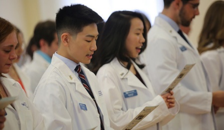 students receiving their white coats. 