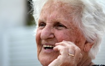 An elderly woman smiling. 