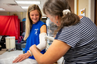 Occupational therapy Students participate in a prosthetics and orthotics lab in April 2022 at Kimball Hall. They were tasked with making arm and finger casts. Photographer: Meredith Forrest Kulwicki 
