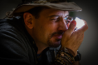 Travis Nelson, geologist and graduate instructional support technician in UB's geology department, inspects a crystal at the 2016 judging. He will return as a judge this year, along with other experts. Credit: Douglas Levere / University at Buffalo