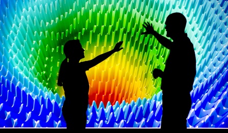 Two people standing in front of a projection screen at the Clinical and Translational Science Institute. 