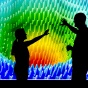 Two people standing in front of a projection screen at the Clinical and Translational Science Institute. 