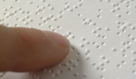 fingertip touching braille. 