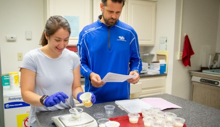 Student in class with faculty member, Dr. Adam Gracyk. 