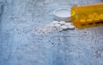 Opioid and prescription drug epidemic concept with pills and bottle and room for copy text.