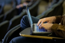 Student typing on laptop. 
