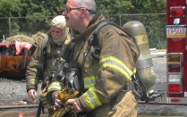 Zoom image: two firefighters preparing for the live burn