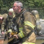 Zoom image: two firefighters preparing for the live burn
