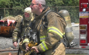 two firefighters preparing for the live burn. 