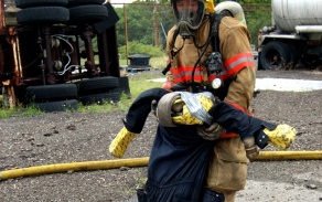 firefighter pulling dummy to safety. 