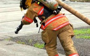firefighter pulling hose. 