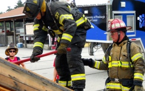 firefighter axing wood wall. 