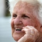 An elderly woman smiling. 