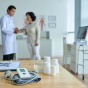 A doctor talking to a patient in a doctors office. 