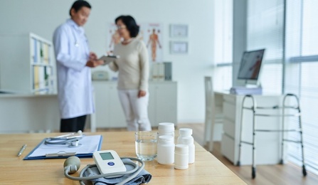 A doctor talking to a patient in a doctors office. 