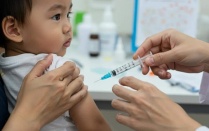 A doctor giving a vaccine to an infant. 