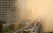 An overhead view of a highway covered in smog. 