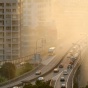 An overhead view of a highway covered in smog. 
