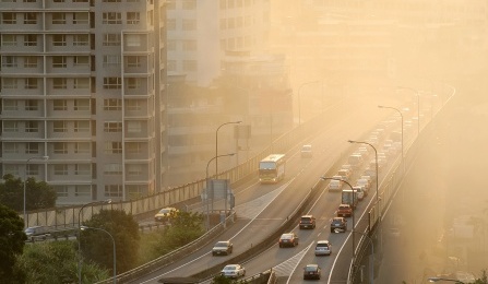 An overhead view of a highway covered in smog. 