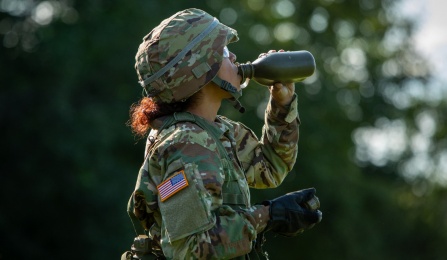 Female soldier drinking from water bottle Photographer: Meredith Forrest Kulwicki. 