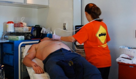 medical technician examining firefighter. 