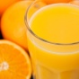 Photo of oranges and a glass of orange juice. 