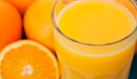 Photo of oranges and a glass of orange juice. 