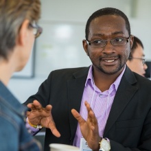 Emmanuel Frimpong Boamah, assistant professor of urban and regional planning, chats with Kasia Kordas, associate professor of epidemiology and environmental health, during the Air Quality Ideas Lab at UB this summer. Photo: Meredith Forrest Kulwicki. 