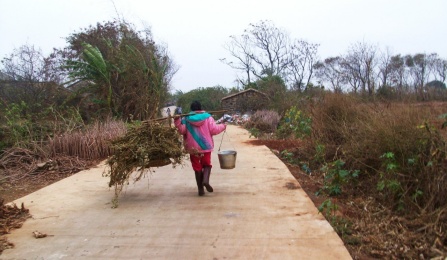 Chinese woman carrying supplies. 