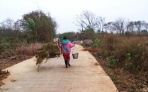 Chinese woman carrying supplies. 