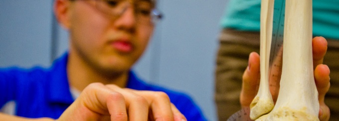 Physical Therapy Student Jeffrey Sam in a Kimball Tower lab with classmates. 