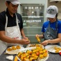 Two SPHHP nutrition students assemble a meal for the UB community as part of their nutrition coursework. 