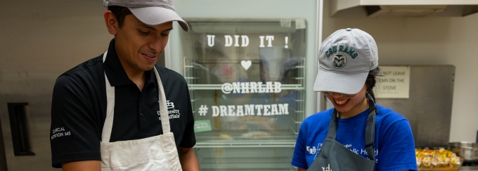 Two SPHHP nutrition students assemble a meal for the UB community as part of their nutrition coursework. 