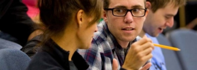 Students in a lecture class having a one-on-one discussion. 