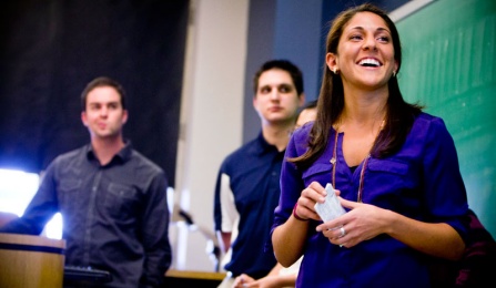 Students presenting in front of class. 