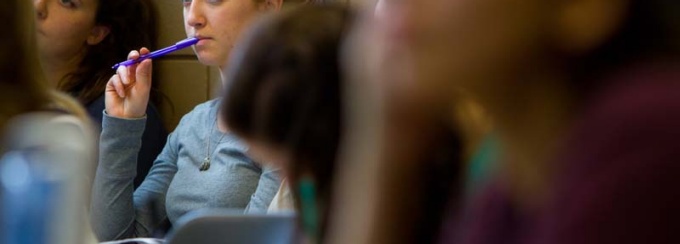 Students engaging in thought during a lecture. 