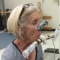 Female volunteer participates in resistive respiratory muscle exercise study. 