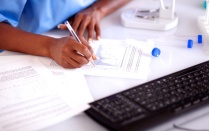 Bottles and glasses of assorted alcoholic beverages isolated on white background. 