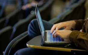 student typing on laptop. 